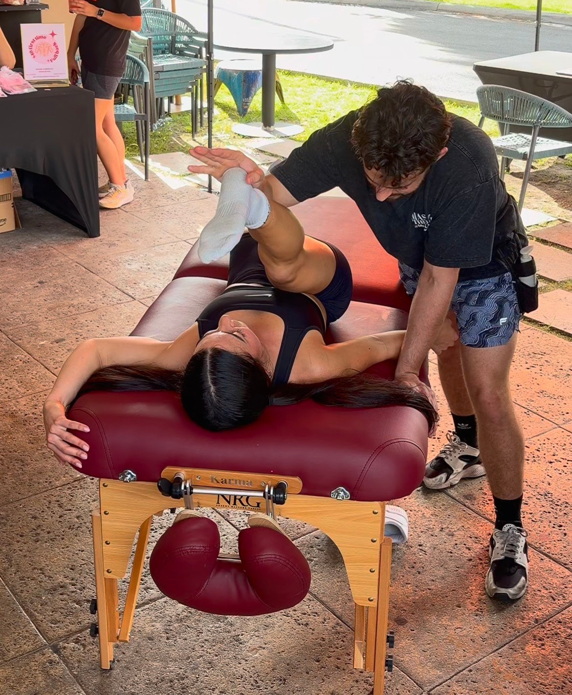 On-site massage demo with a portable table at an outdoor event