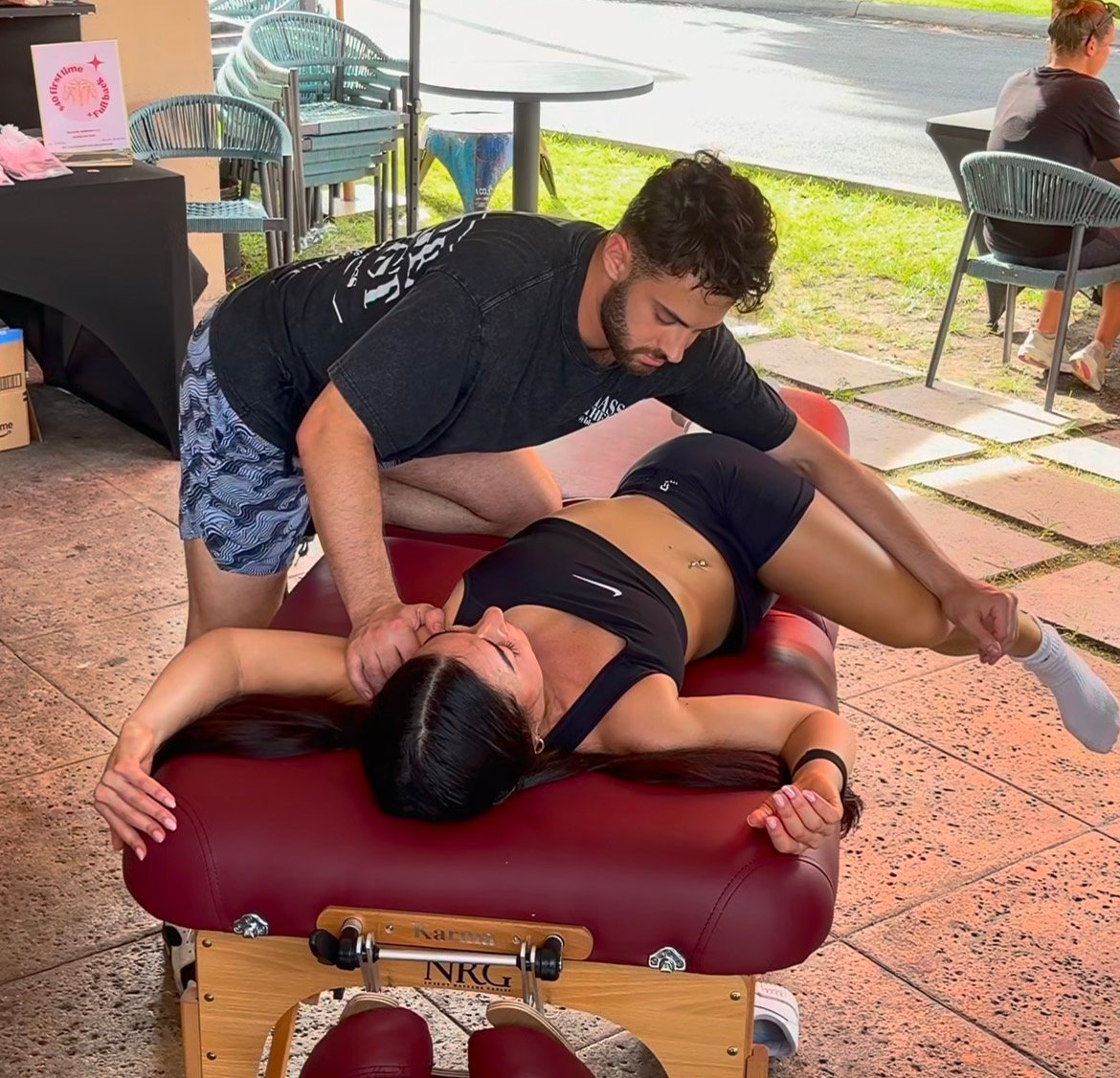 Assisted stretching demonstration at an outdoor event